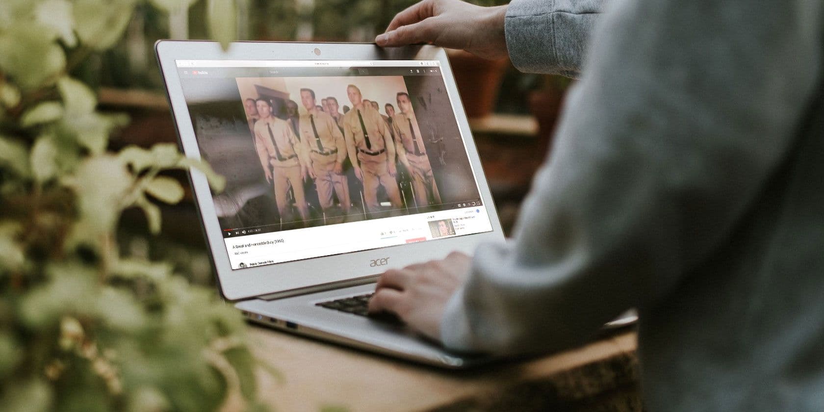 Man's hands opening laptop to watch a movie on the screen